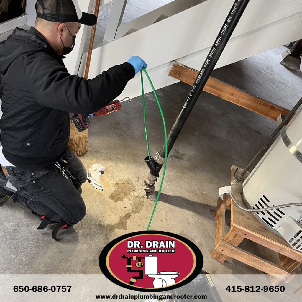 Plumber performing hydro jetting on outdoor drain system in San Francisco before rainy season