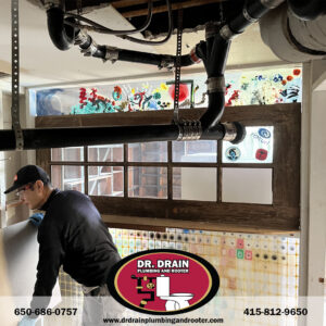 Emergency plumber responding to burst pipe in San Francisco home during early fall season