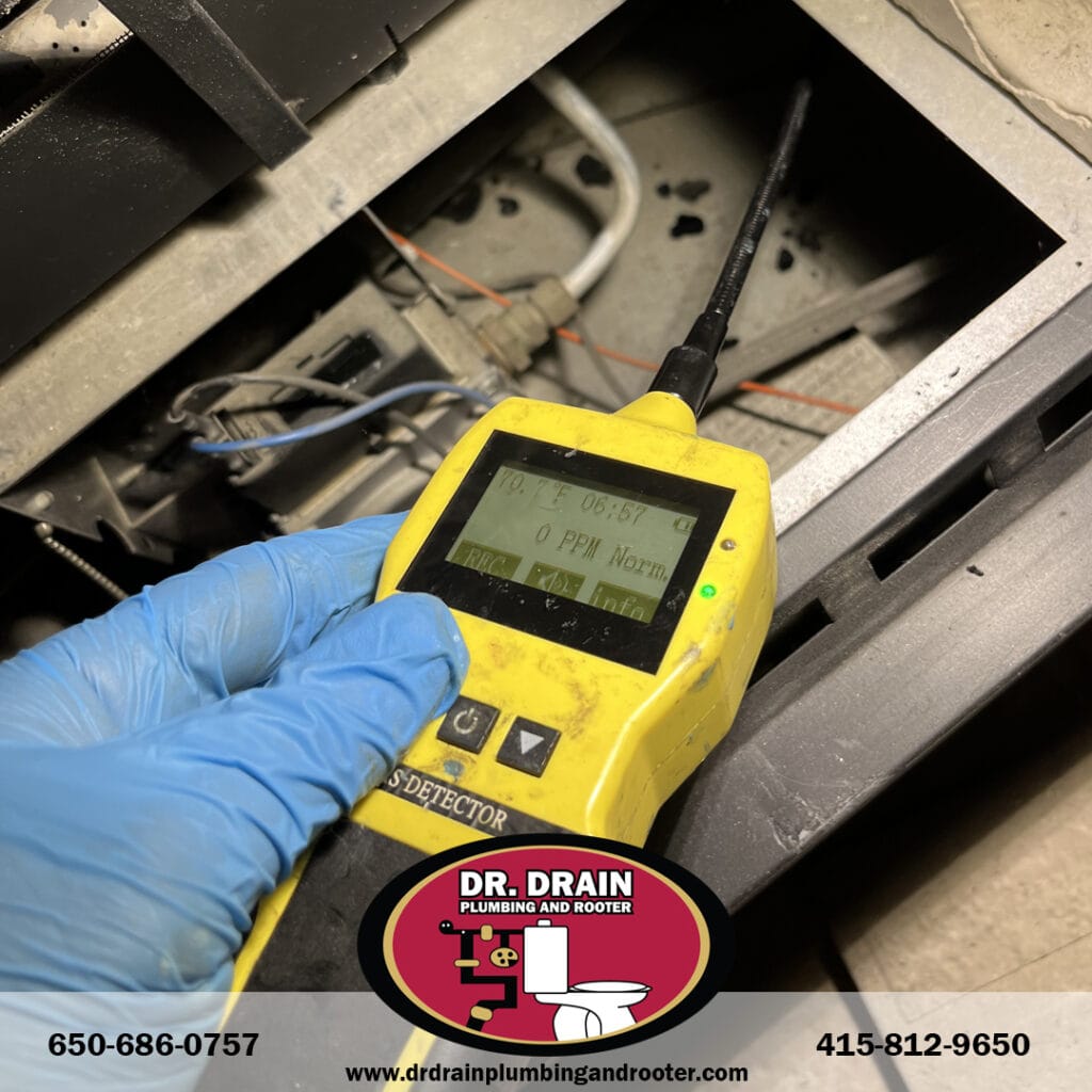 Plumber using acoustic leak detection tools in San Francisco home to locate hidden pipe issues