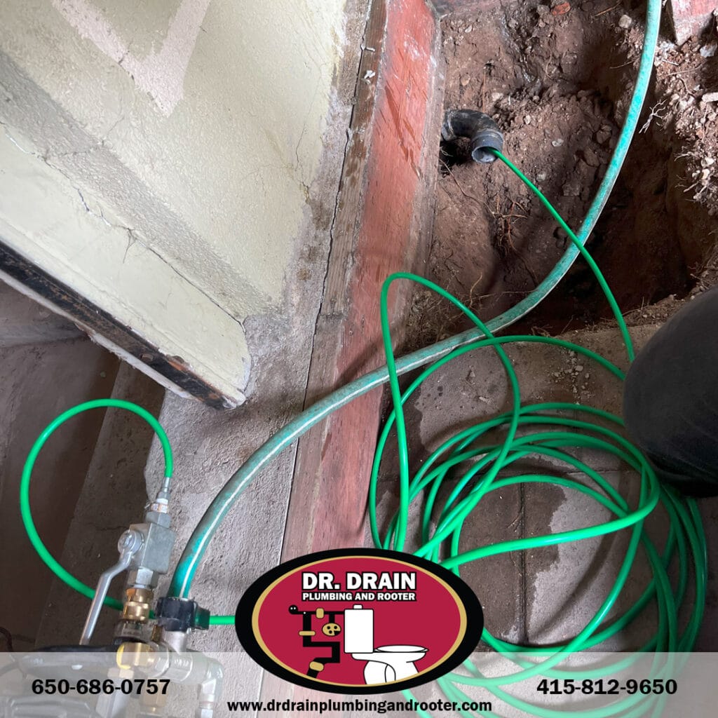 Technician performing hydro jetting on clogged drain in San Francisco home