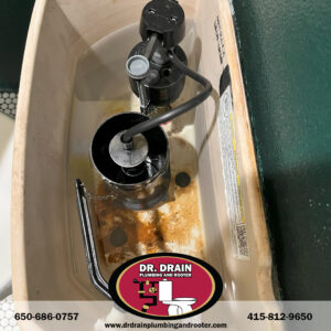 Plumber inspecting exposed pipes for winter readiness in San Francisco home