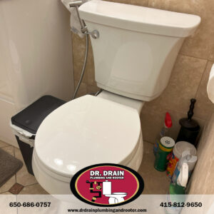 Plumber installing dual-flush toilet in San Francisco bathroom